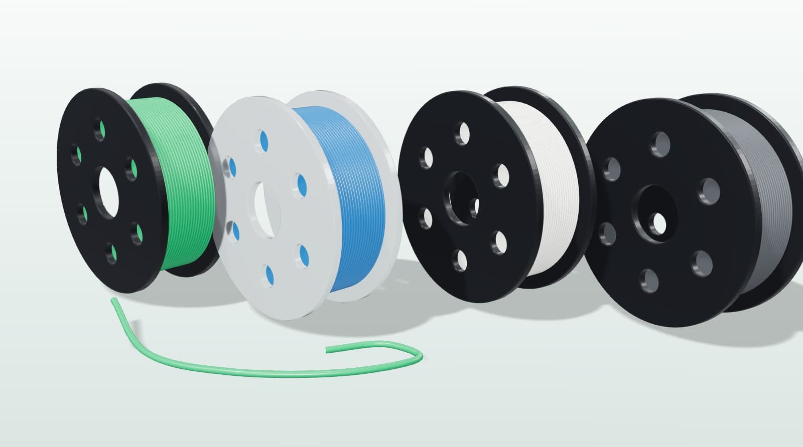 Green, translucent blue, white and grey filament spools